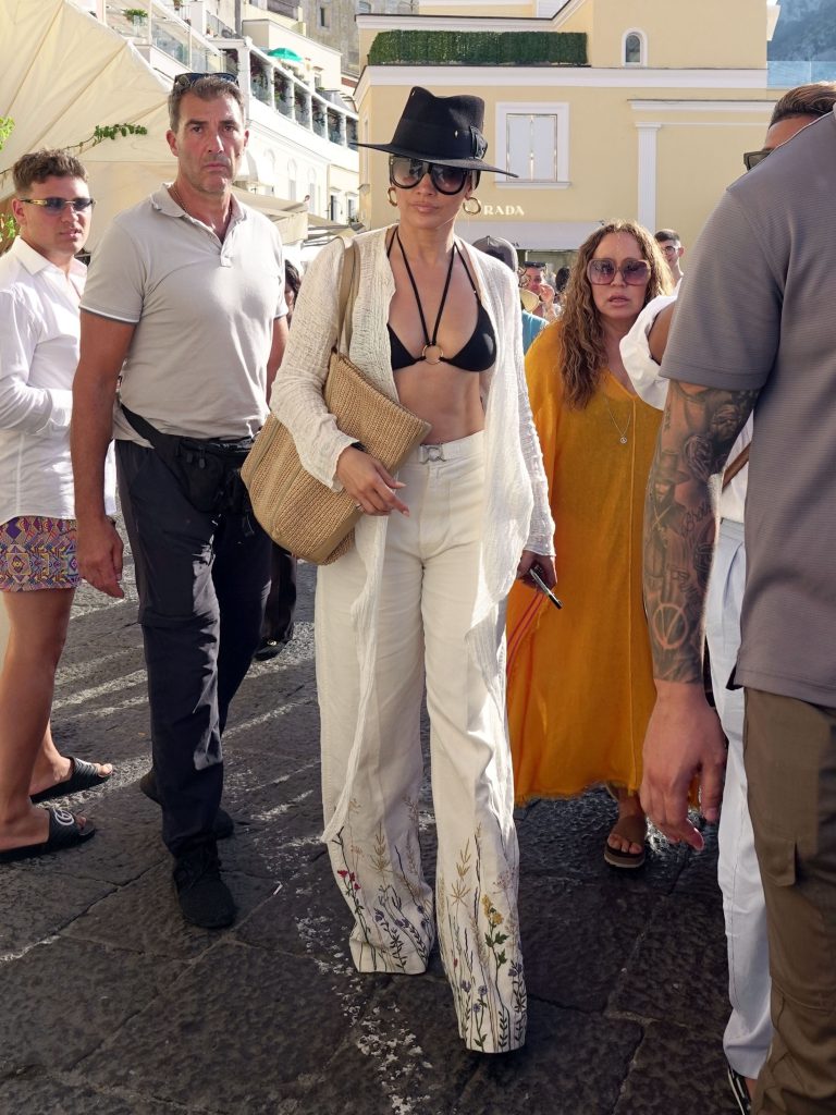 The American Singer And Actress Jennifer Lopez Looks Chic And Stylish Pictured Shopping Through Town Followed By Her Entourage During Her Summer Holidays In Capri.