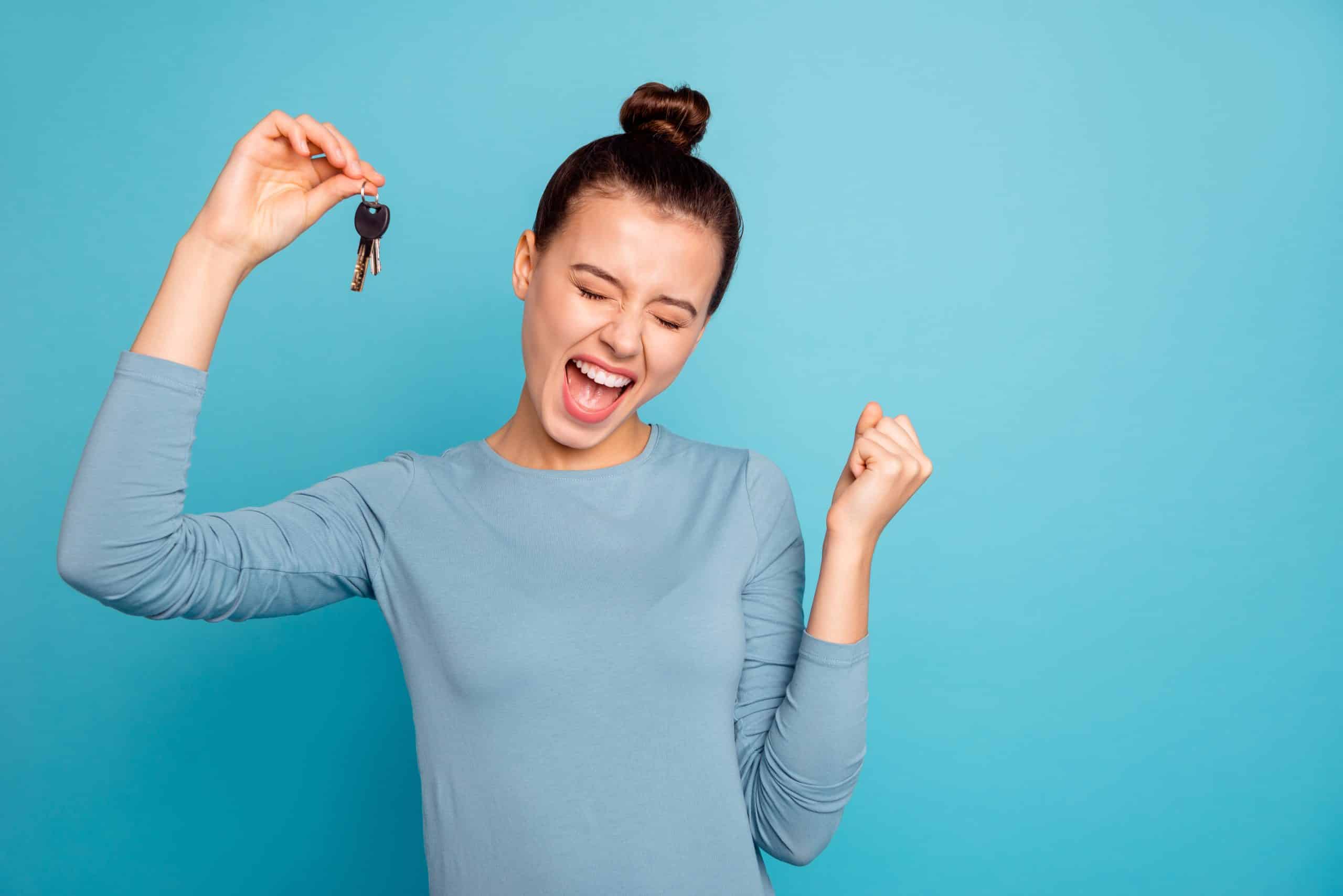 Portrait Of Delighted Lady Luck Lucky Triumph Raise Fists Close Eyes Content Rejoice Scream Shout Yeah Mover Move In Settlement Loan Beautiful Bun Trendy Stylish Sweater Isolated On Blue Background