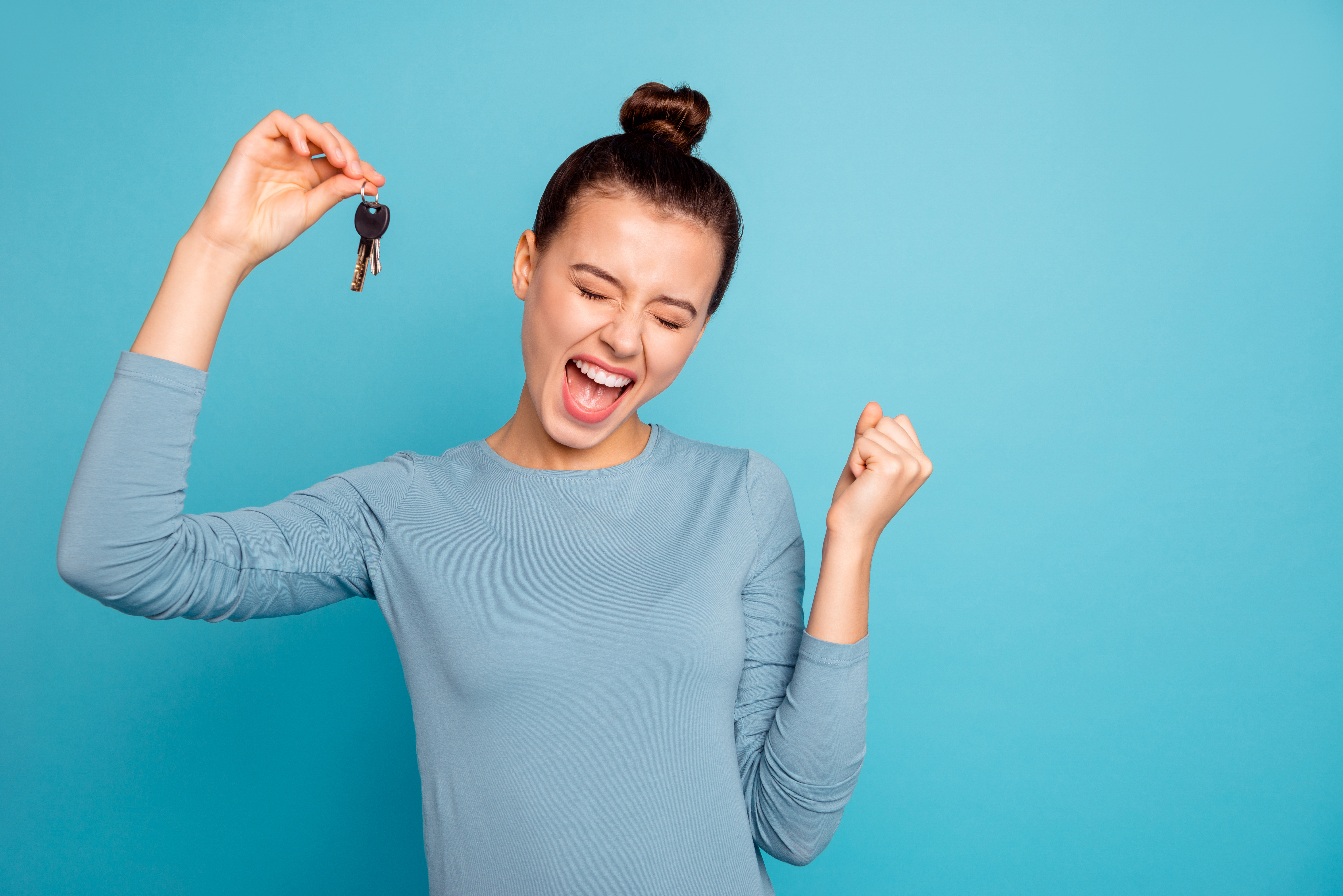 Portrait Of Delighted Lady Luck Lucky Triumph Raise Fists Close Eyes Content Rejoice Scream Shout Yeah Mover Move In Settlement Loan Beautiful Bun Trendy Stylish Sweater Isolated On Blue Background